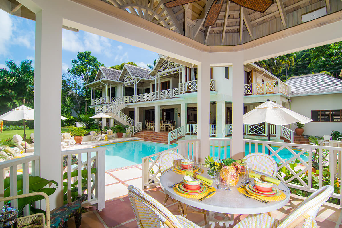 Pineapple House pool area and table with fresh Caribbean food