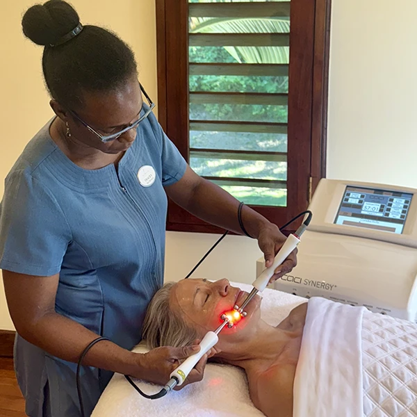 a woman receiving CACI facial treatment