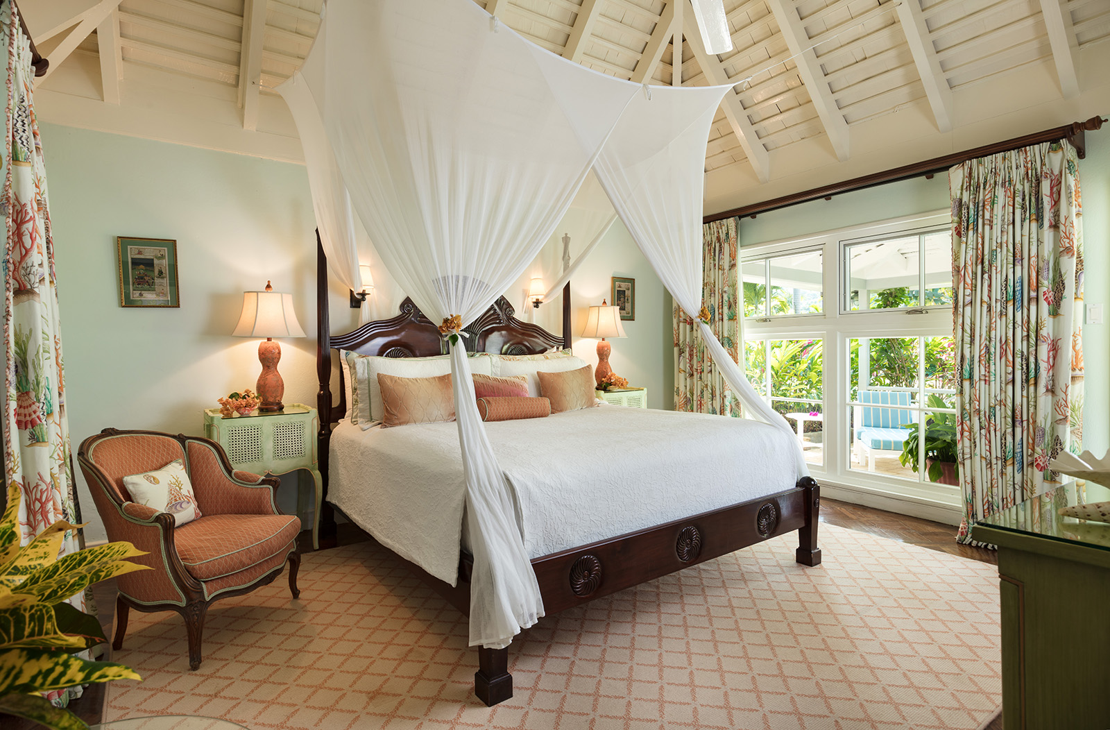 Little Hill villa bedroom with four-poster bed and a chair