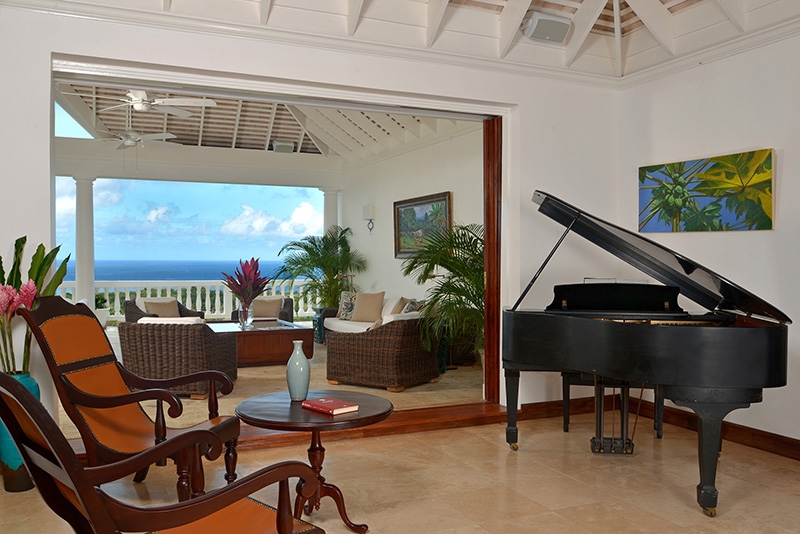 Villa Amana room with grand piano and view of the Caribbean Sea
