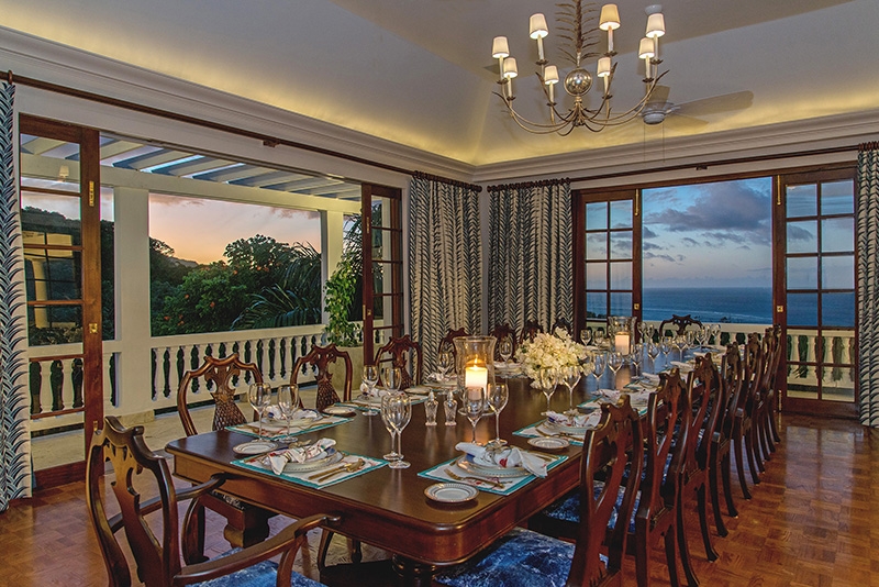 Villa Amana a large dining table laid out with candles at dusk
