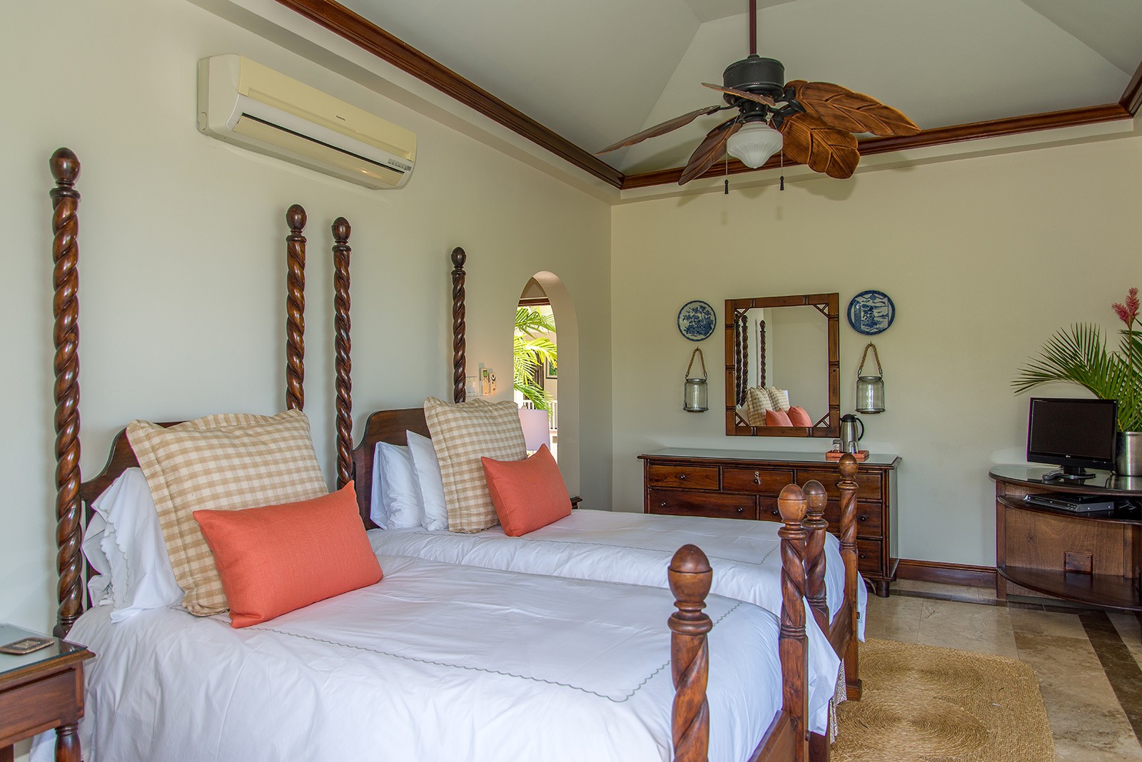 Sea Glass villa twin bedroom with beds and orange pillows