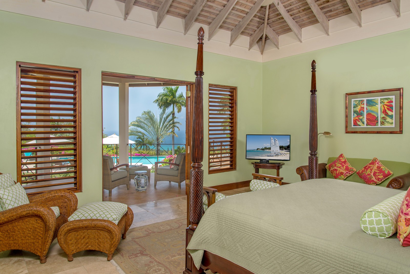 Sugar Hill villa room with a bed looking out over the Caribbean Sea