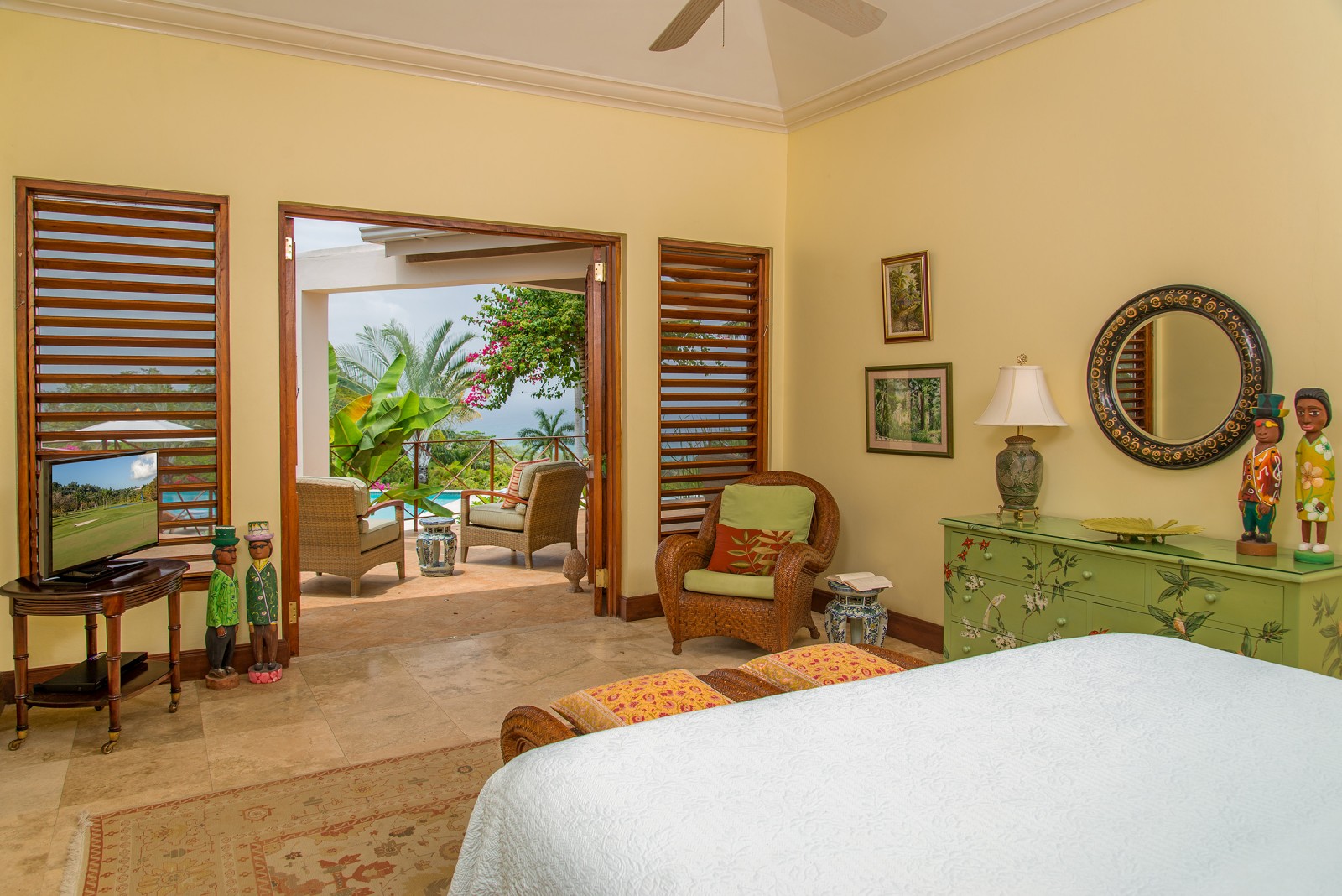 Sugar Hill villa room with bed and orange foot stool