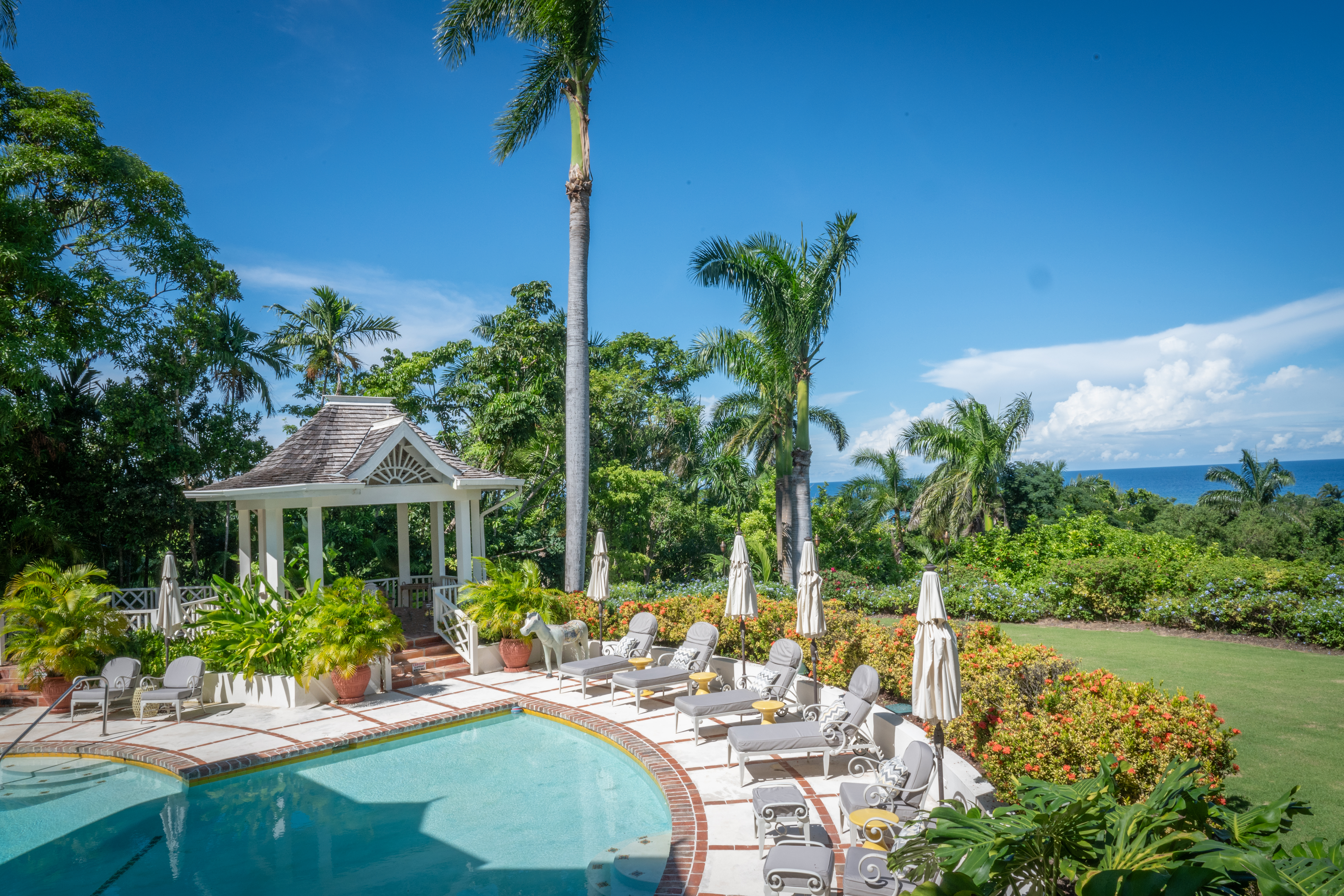 Pineapple House pool area, sun loungers and Caribbean Sea