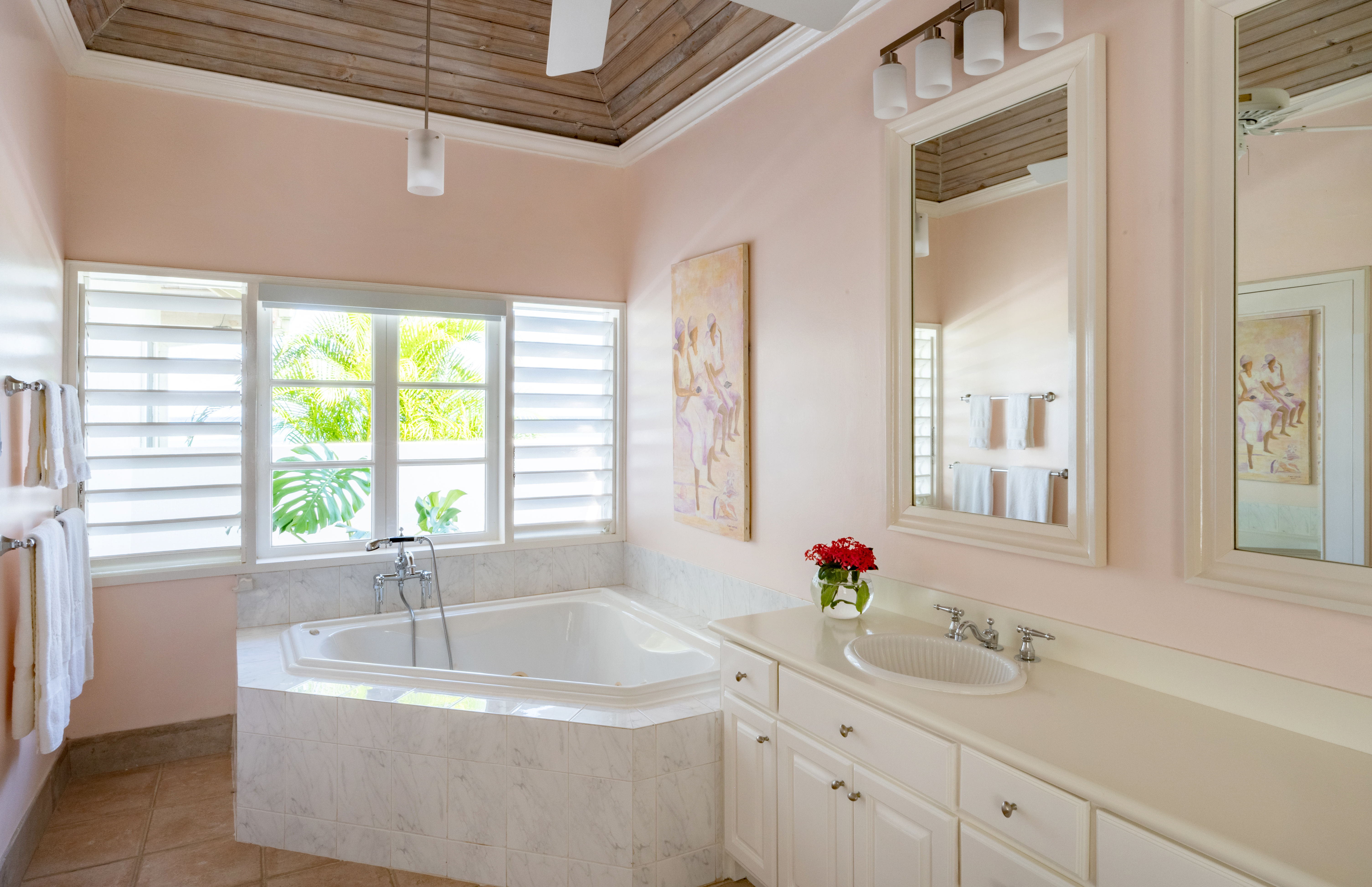 Phoenix villa bathroom with corner bath and wash basin
