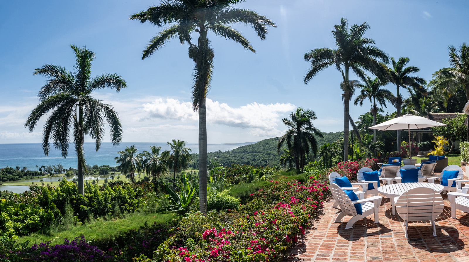 Casuarina villa outside seating areas with palm trees overlooking the Caribbean sea