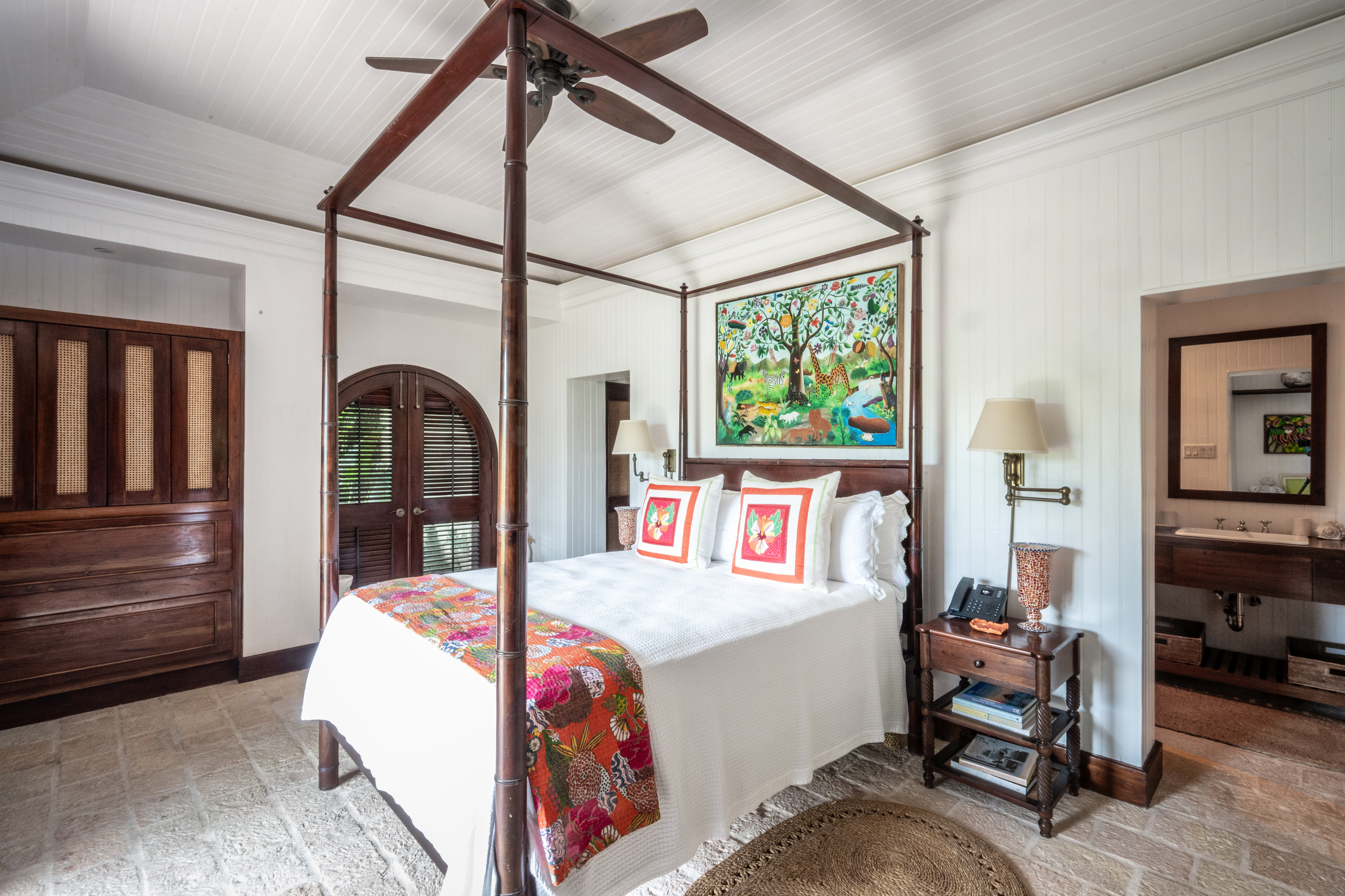 Point of View villa four-poster bed and a painting of a tree