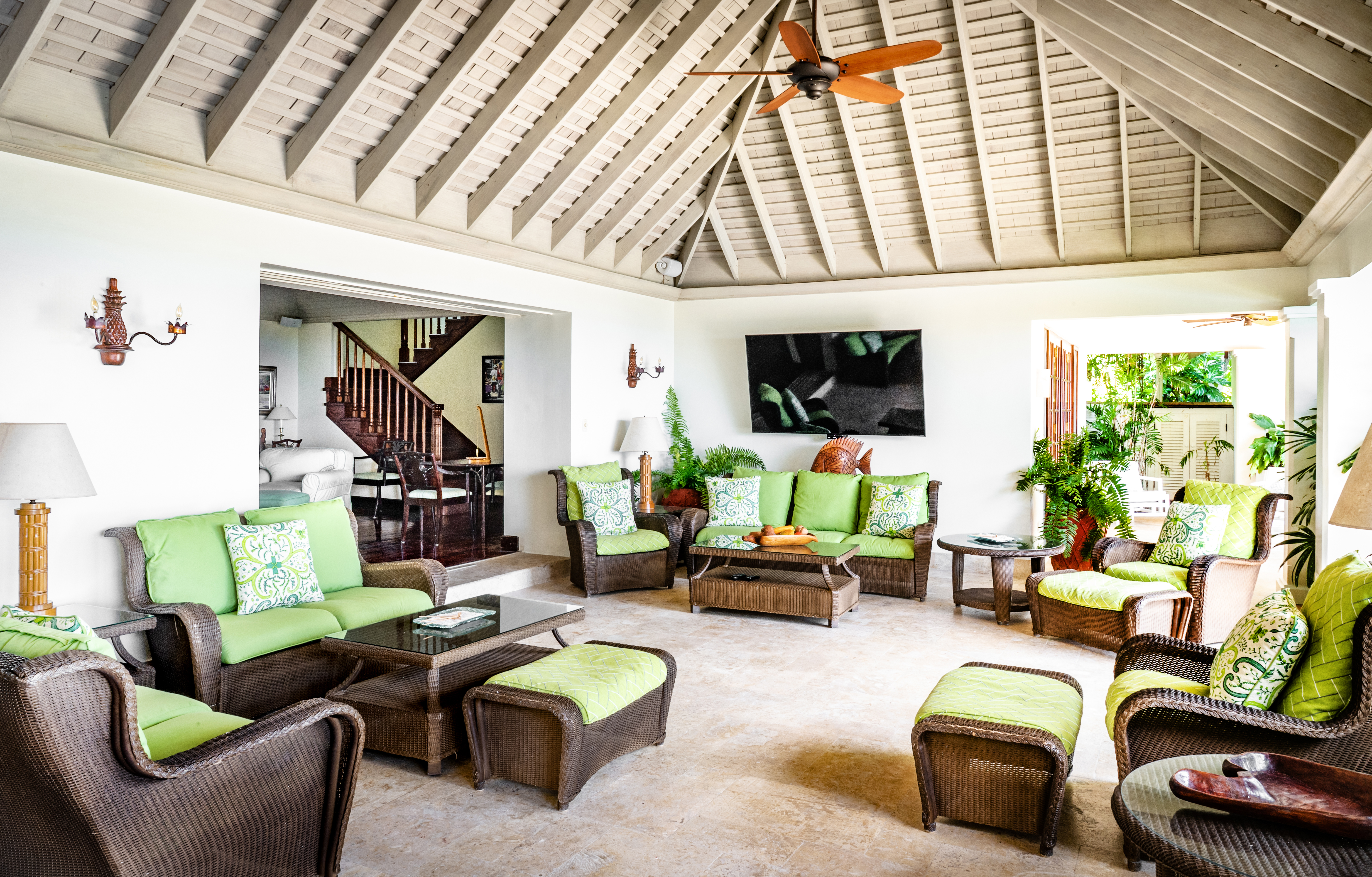 Someday Soon villa seating area with green cushions