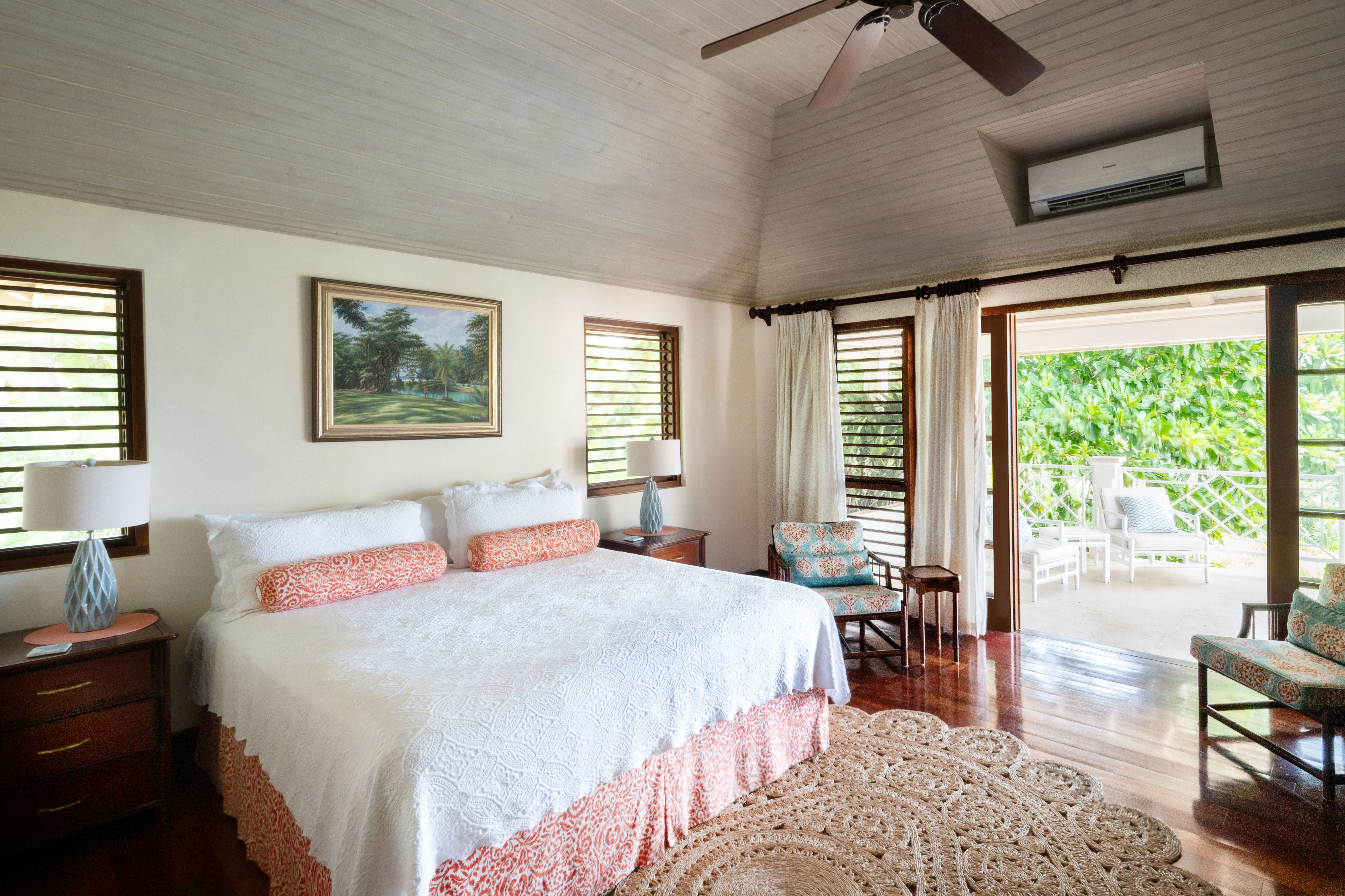 Someday Soon villa bedroom with a large bed and open doors