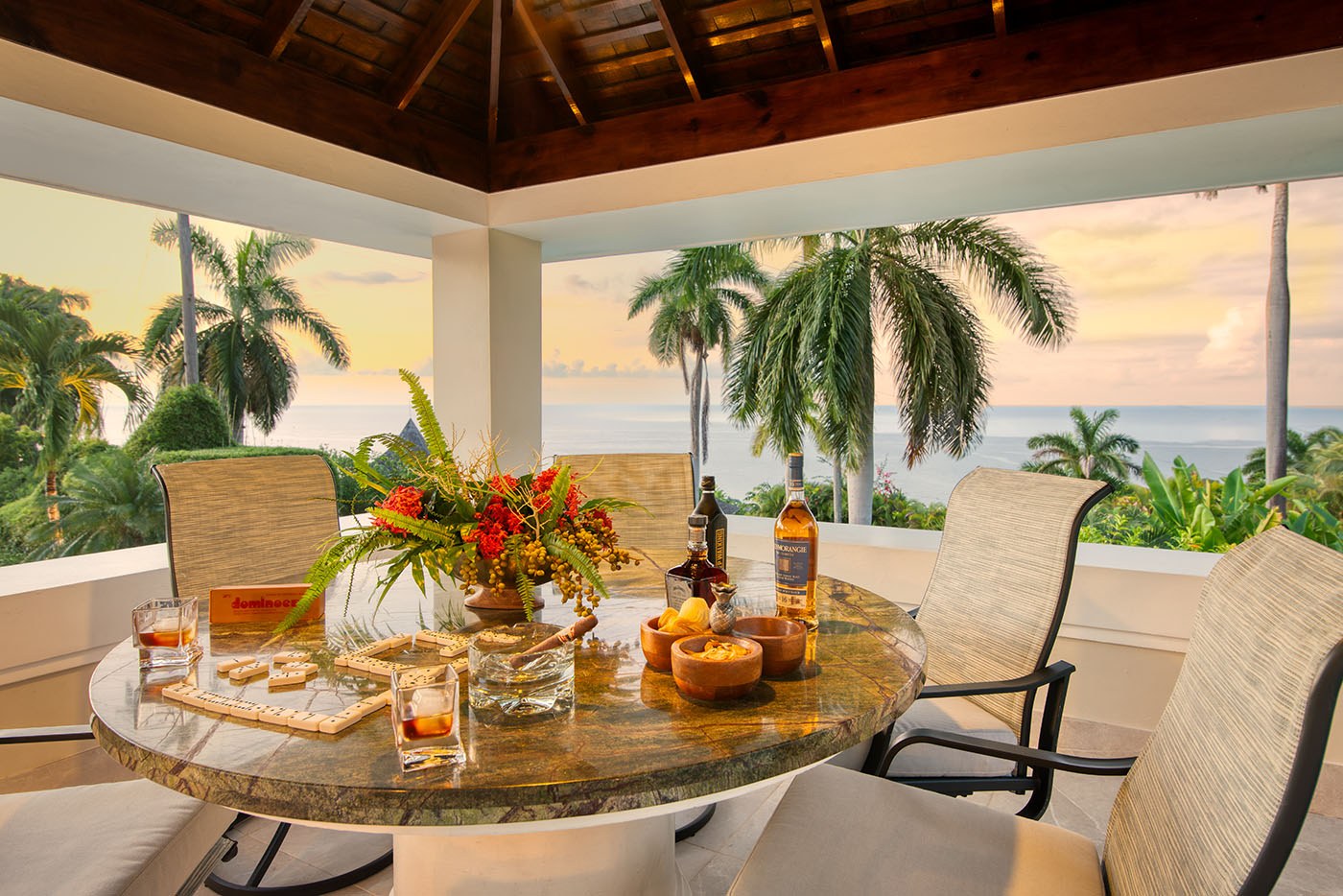 Trinity Villa table and chairs with snacks next to the Caribbean Sea